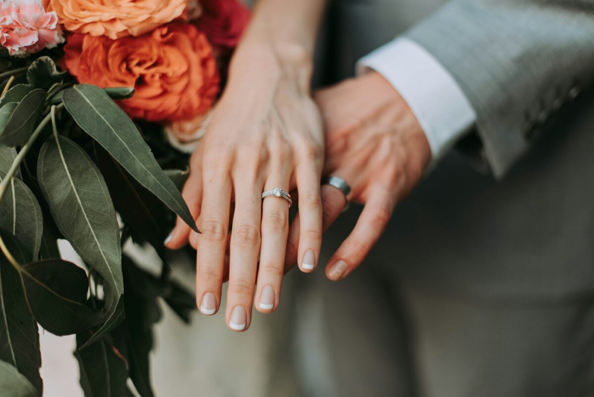 Couple holding hands wearing their rings